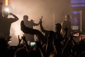 A fan crowdsurfing during I Prevail's performance