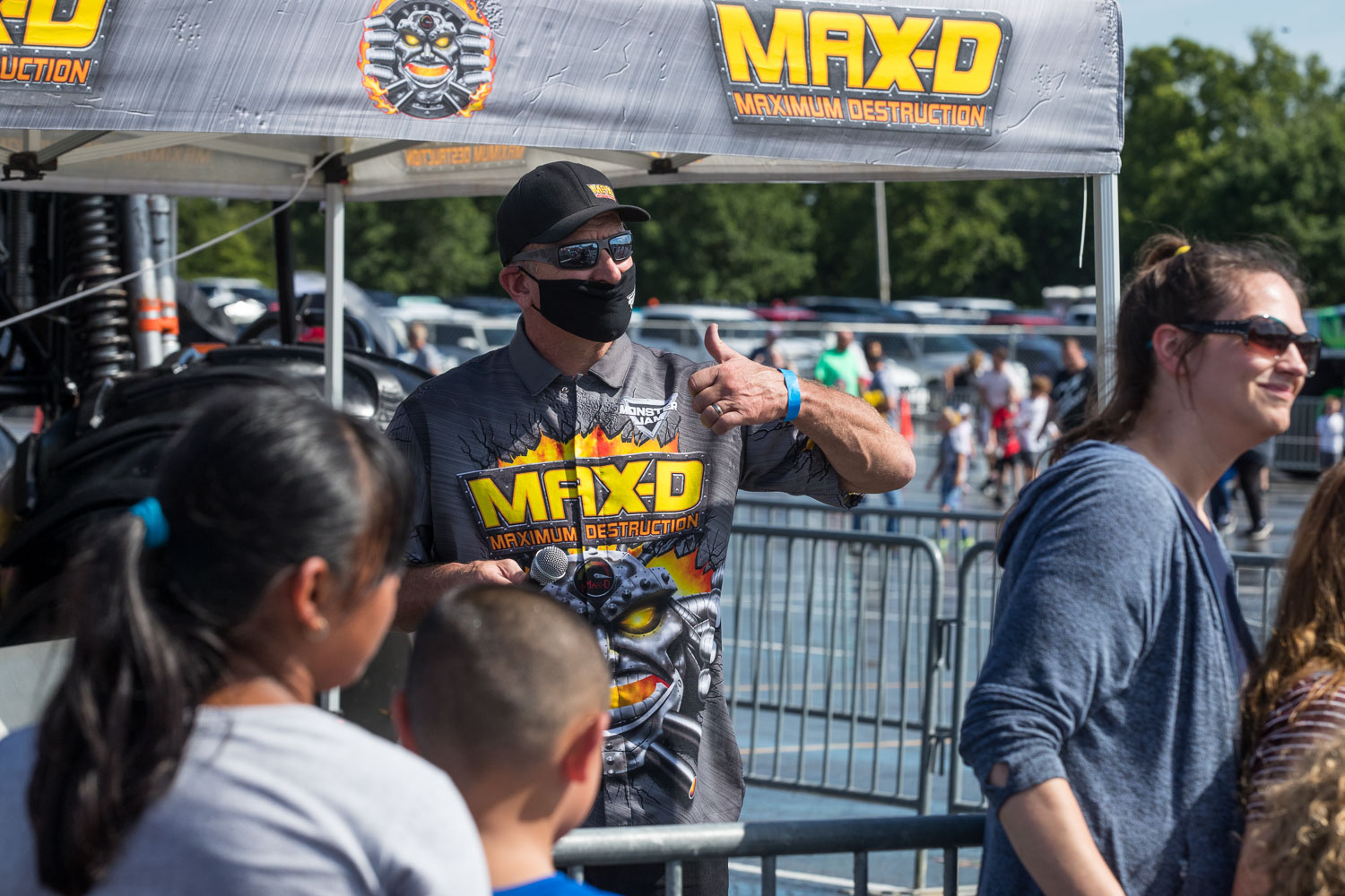 Tom Meents, driver of the Maximum Destruction (Max-D) truck, poses for a photo with fans during the Monster Jam Pit Party prior to the main event at GEHA Field at Arrowhead on Saturday evening, June 26, 2021.