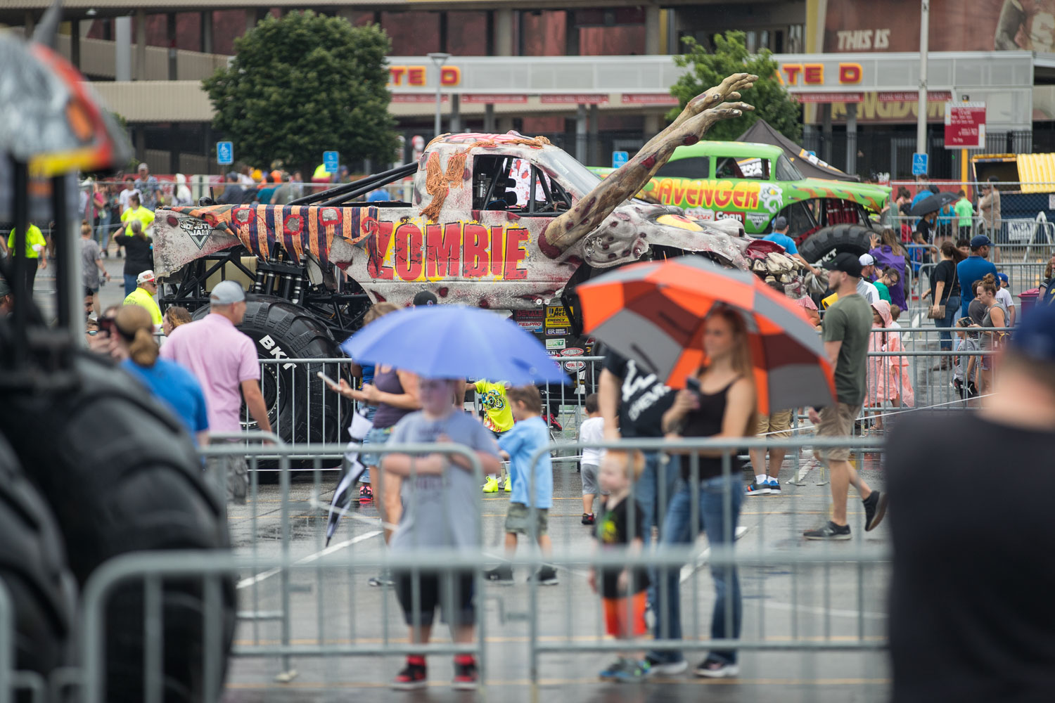 Fans brave the rain while checking out the trucks during the Monster Jam Pit Party prior to the main event at GEHA Field at Arrowhead on Saturday evening, June 26, 2021.