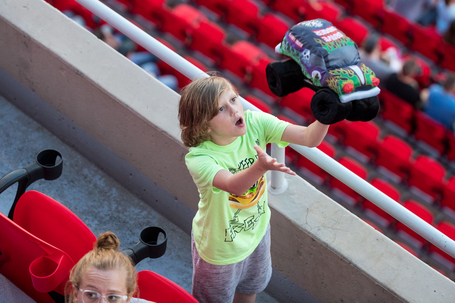 A young fan tosses a stuffed Gravedigger plush in the air during Monster Jam at GEHA Field at Arrowhead on Saturday evening, June 26, 2021.