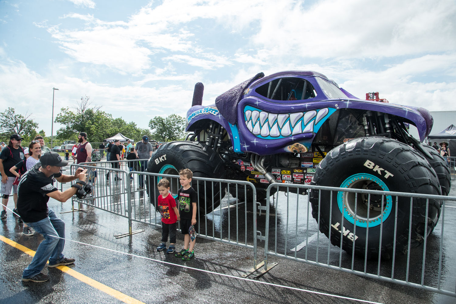 Young fans pose for a quick photo in front of the Monster Mutt truck during the Monster Jam Pit Party prior to the main event at GEHA Field at Arrowhead on Saturday evening, June 26, 2021.