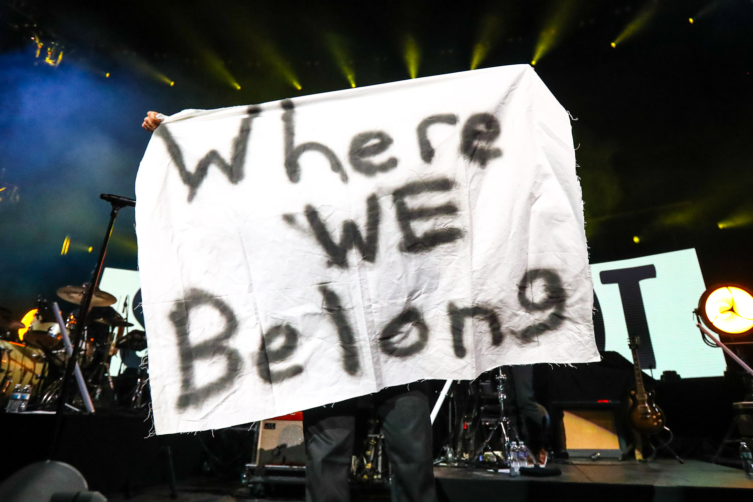 Jon Foreman of Switchfoot holding up a Where We Belong sign