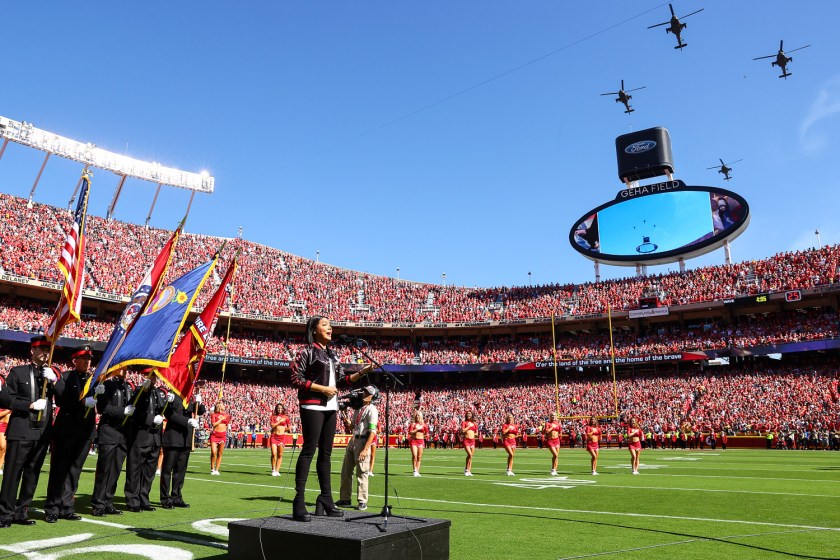 Good Morning America reporter and Army Reserve Major Stephanie Ramos sings the national anthem as four Apache helicopters fly overhead prior to the week three NFL football game against the Chicago Bears, Sunday, September 26, 2023 in Kansas City.