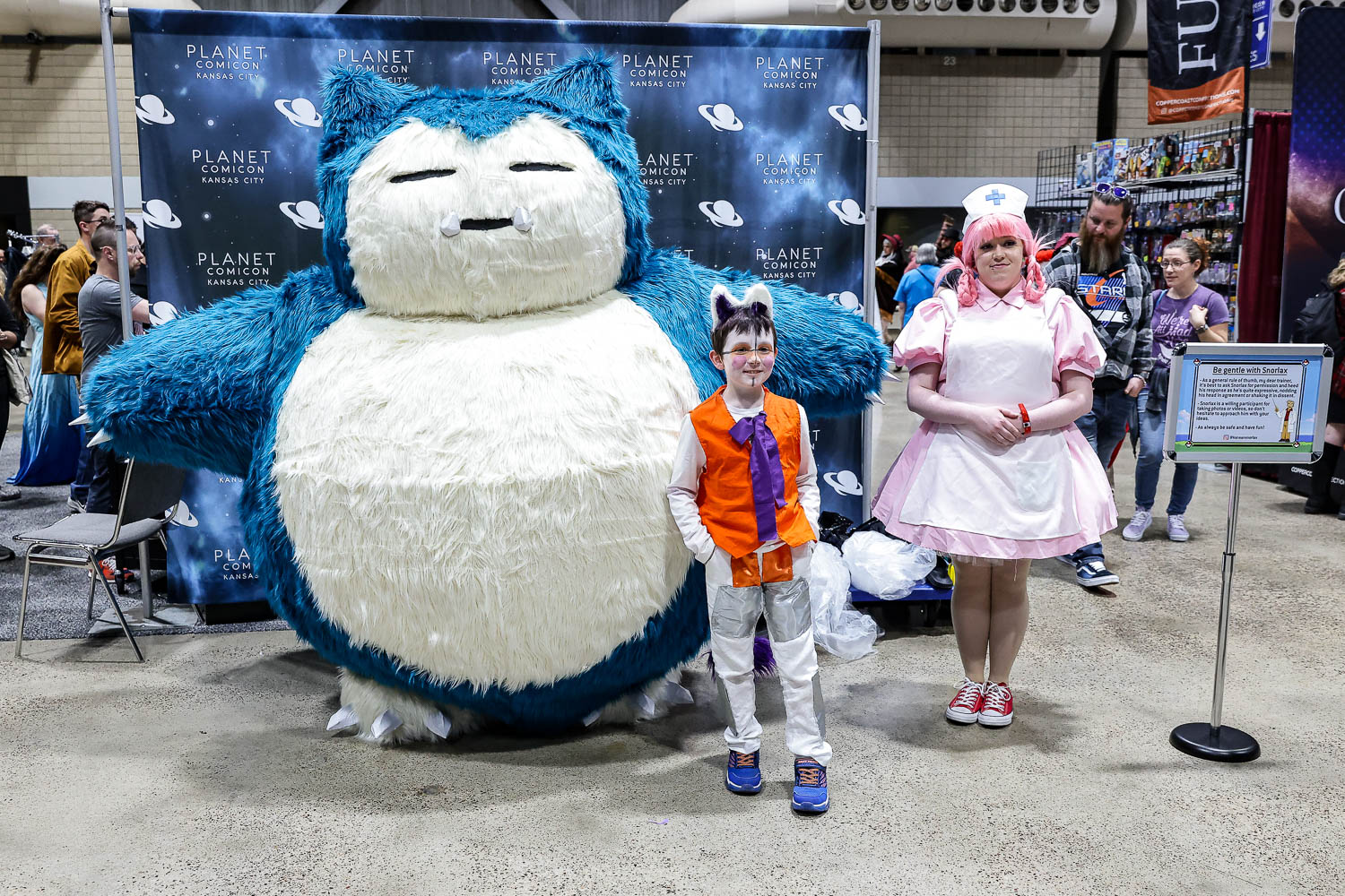 Pokemon Snorlax and Nurse Joy cosplayers on Saturday at the 2023 Planet Comicon in Kansas City, Missouri on March 18, 2023.